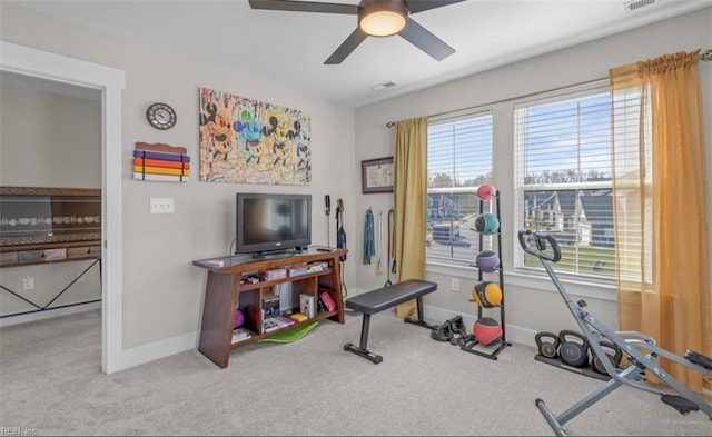 exercise area featuring ceiling fan, plenty of natural light, and carpet