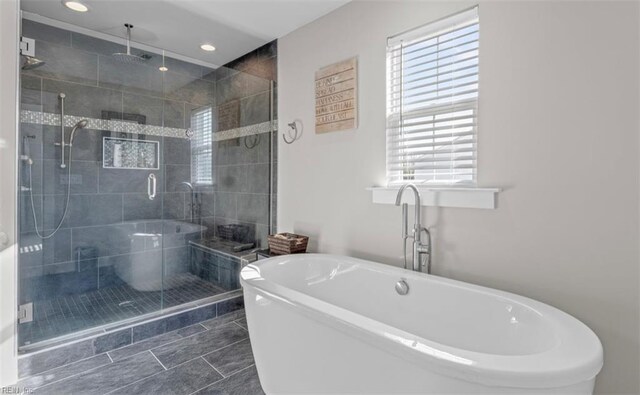 bathroom featuring tile patterned flooring and plus walk in shower