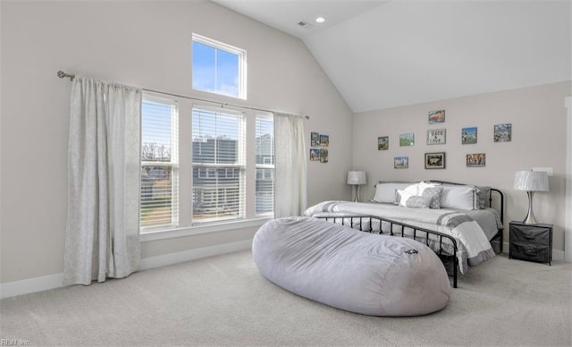 bedroom with light carpet and high vaulted ceiling