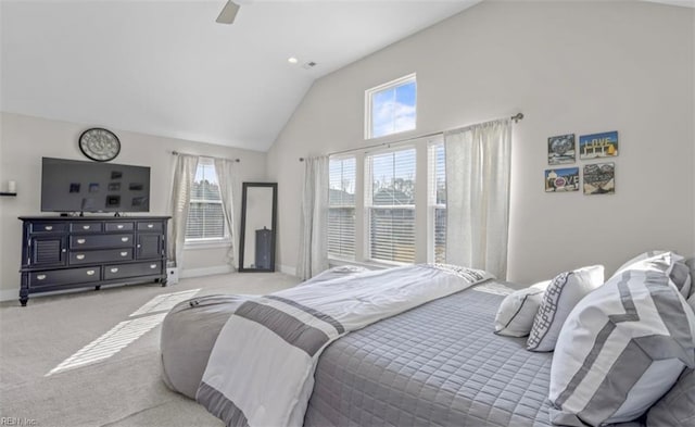 carpeted bedroom featuring high vaulted ceiling and ceiling fan