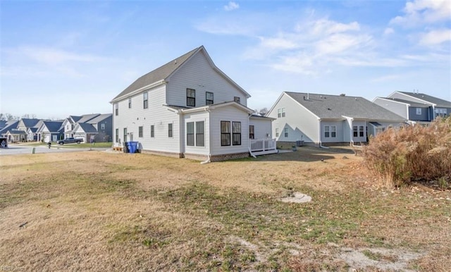 rear view of house with a yard