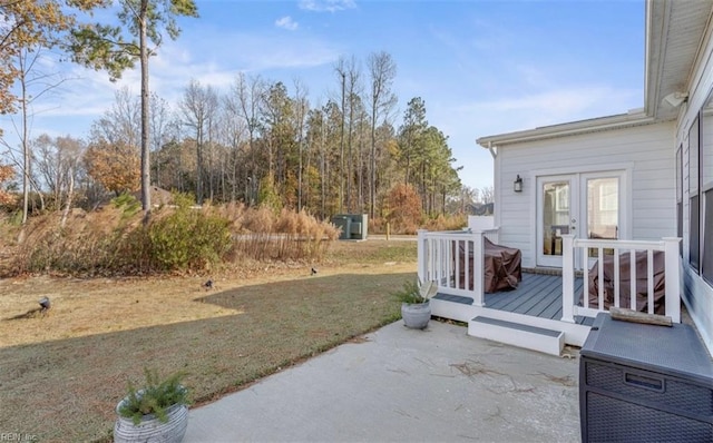 view of yard with a patio area and a wooden deck