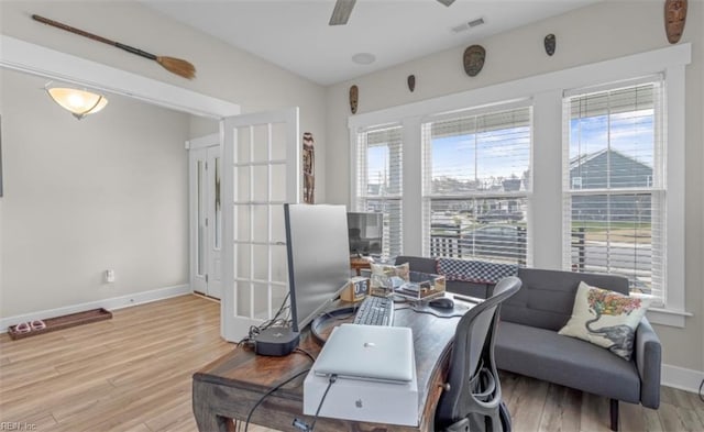 office with ceiling fan and light hardwood / wood-style floors