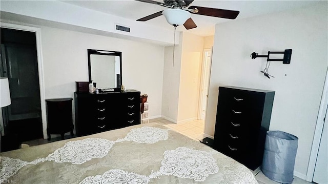 tiled bedroom with ceiling fan