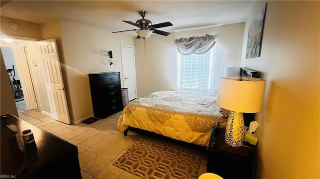 bedroom with ceiling fan and light tile patterned floors