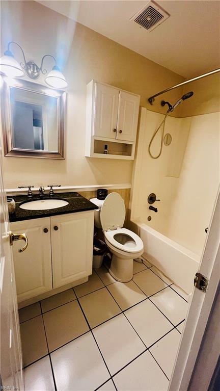 full bathroom featuring tile patterned flooring, shower / bathing tub combination, vanity, and toilet