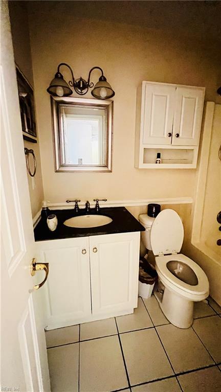 full bathroom with tile patterned flooring, vanity, shower / bath combination, and toilet