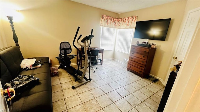 workout area featuring light tile patterned floors