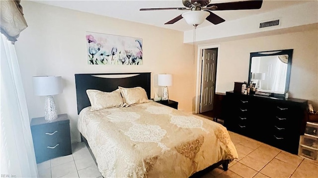 tiled bedroom with ceiling fan