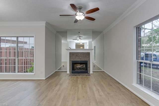 unfurnished living room with ornamental molding, a textured ceiling, and light wood-type flooring