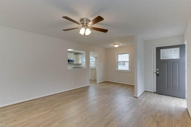 entryway with ceiling fan and light wood-type flooring