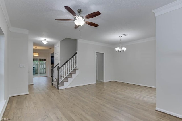 empty room with ceiling fan with notable chandelier, a textured ceiling, light wood-type flooring, and ornamental molding