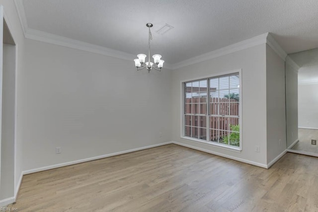 unfurnished dining area featuring a chandelier, a textured ceiling, light wood-type flooring, and crown molding