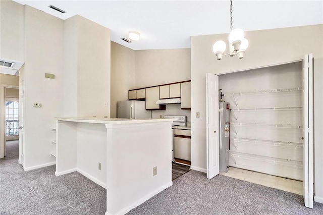 kitchen featuring electric water heater, carpet flooring, appliances with stainless steel finishes, decorative light fixtures, and kitchen peninsula