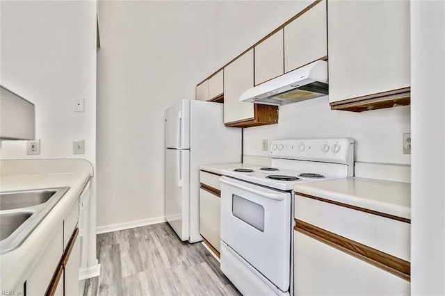 kitchen featuring white cabinets, light wood-type flooring, white range with electric stovetop, and sink