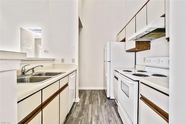 kitchen featuring white cabinets, white appliances, sink, and light hardwood / wood-style flooring