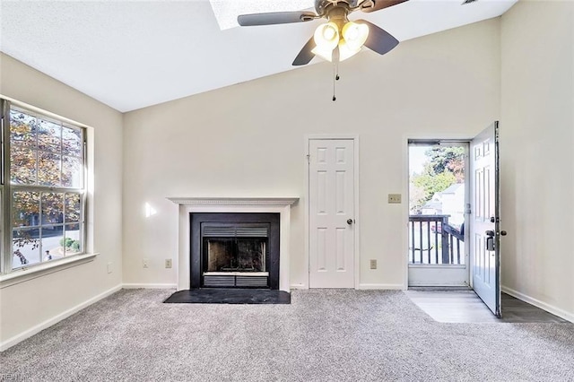 unfurnished living room featuring ceiling fan, high vaulted ceiling, and light colored carpet