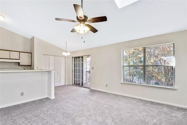 unfurnished living room with light carpet, vaulted ceiling, and a healthy amount of sunlight