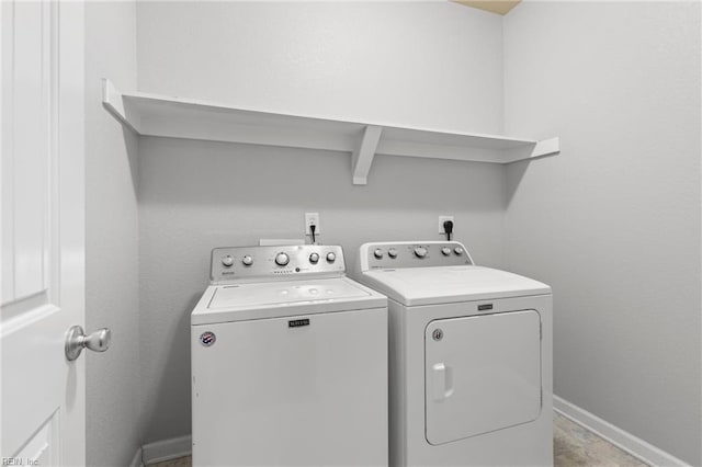 washroom with washing machine and clothes dryer