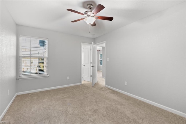 unfurnished bedroom featuring ceiling fan and light colored carpet