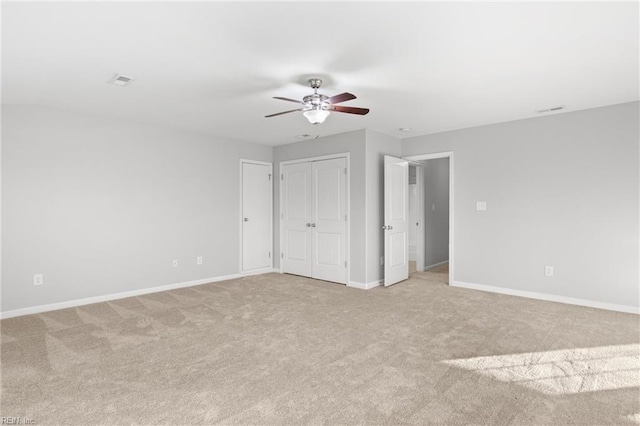 unfurnished bedroom featuring ceiling fan and light colored carpet