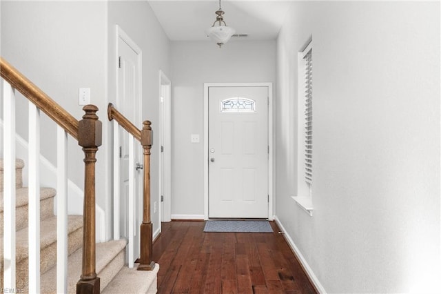 doorway with dark wood-type flooring