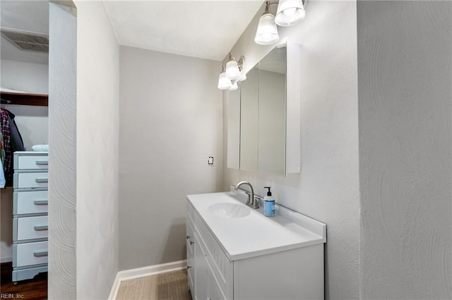 bathroom with hardwood / wood-style floors and vanity