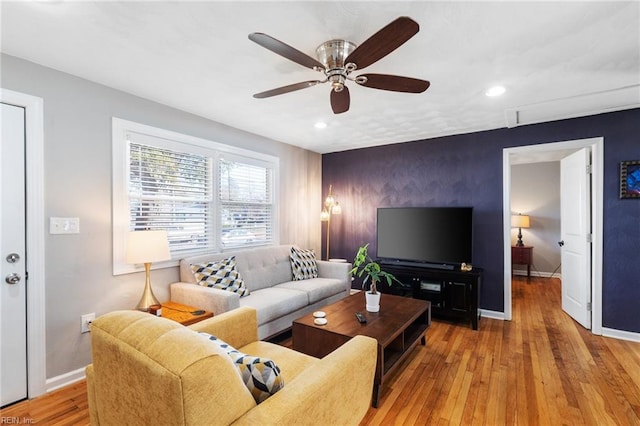 living room featuring ceiling fan and light hardwood / wood-style floors