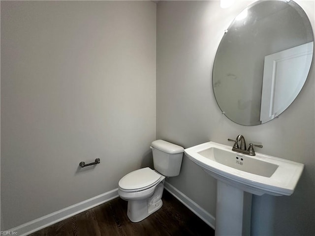 bathroom featuring wood-type flooring and toilet