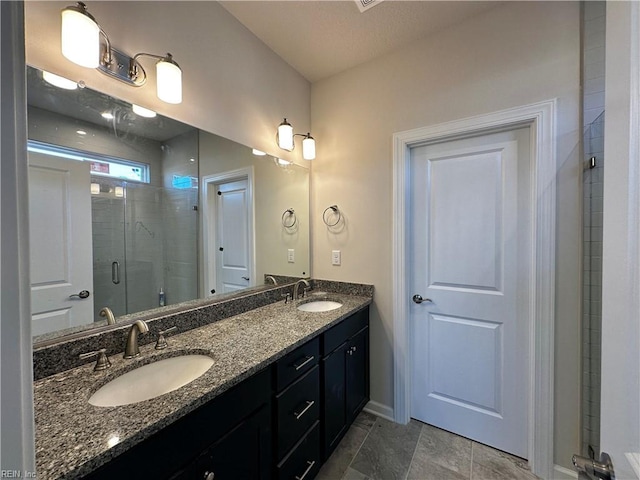 bathroom with vanity, tile patterned flooring, and a shower with shower door