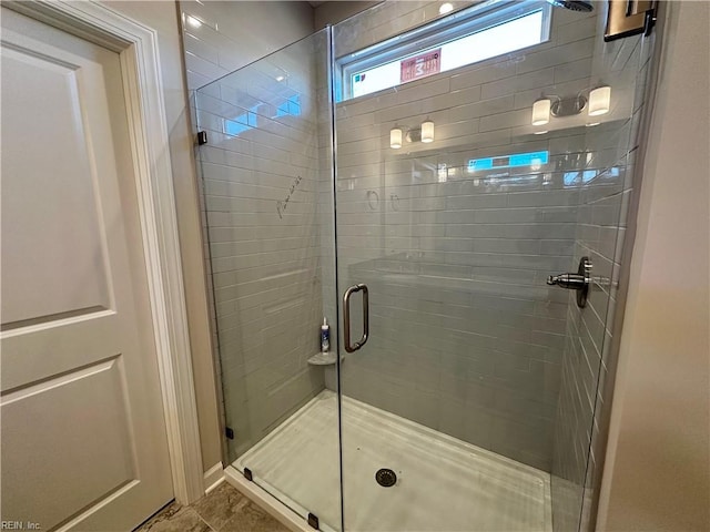 bathroom with tile patterned floors and walk in shower