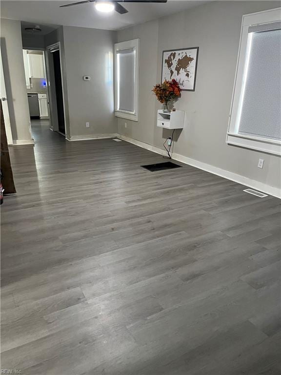 unfurnished room featuring dark hardwood / wood-style floors and ceiling fan