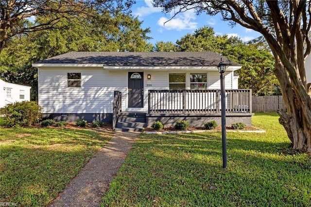 view of front of home featuring a deck and a front lawn