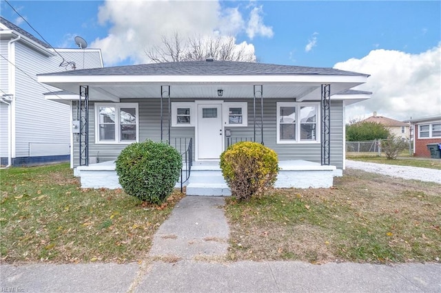 bungalow-style home with a front yard