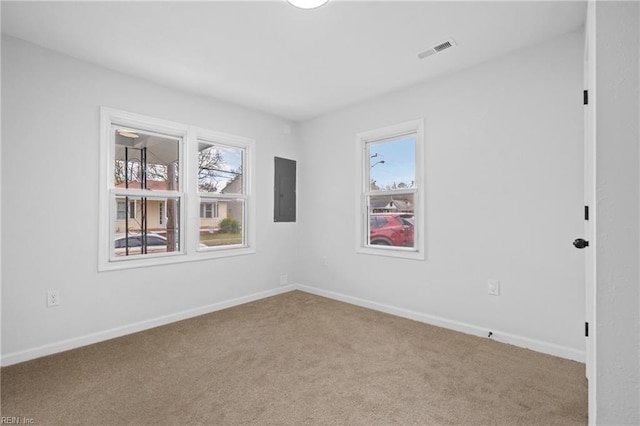 carpeted empty room featuring electric panel