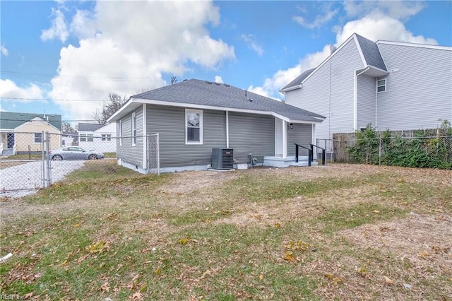 back of property featuring a yard and central AC unit