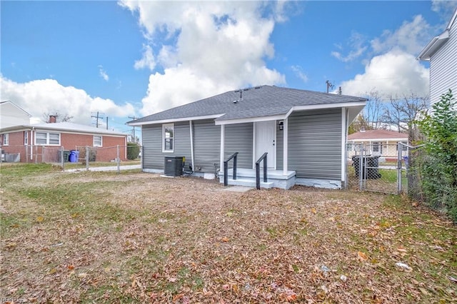 back of property featuring a yard and central AC unit