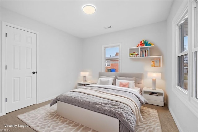 bedroom with light colored carpet