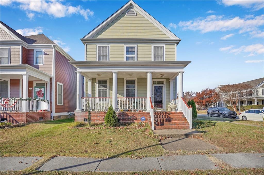 view of front facade featuring covered porch and a front yard