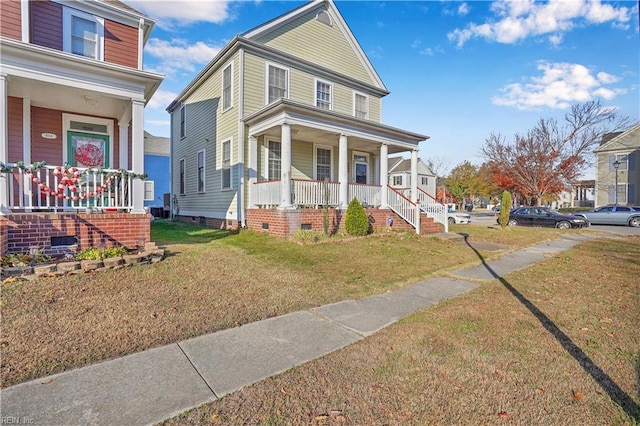 view of front of property featuring a porch and a front lawn