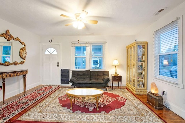 interior space with heating unit, hardwood / wood-style flooring, and ceiling fan