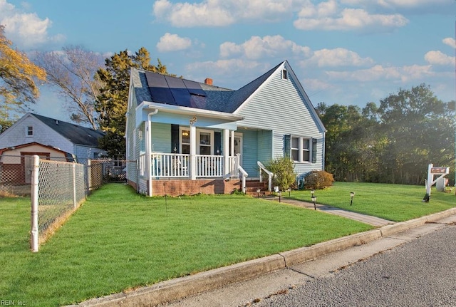 bungalow-style home featuring a front lawn, a porch, and solar panels