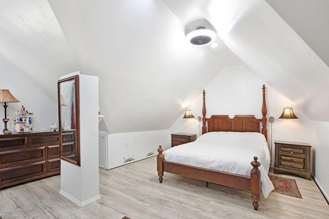 bedroom with light wood-type flooring and lofted ceiling