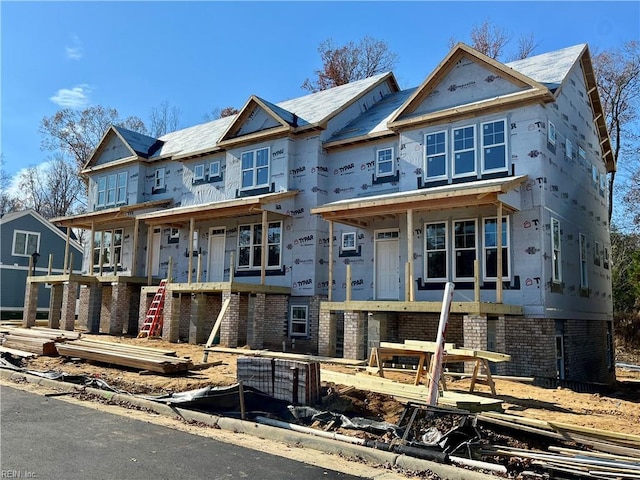 property under construction featuring a garage and brick siding