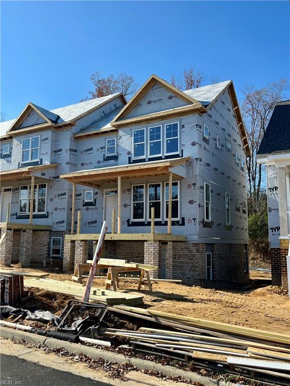 property under construction with brick siding