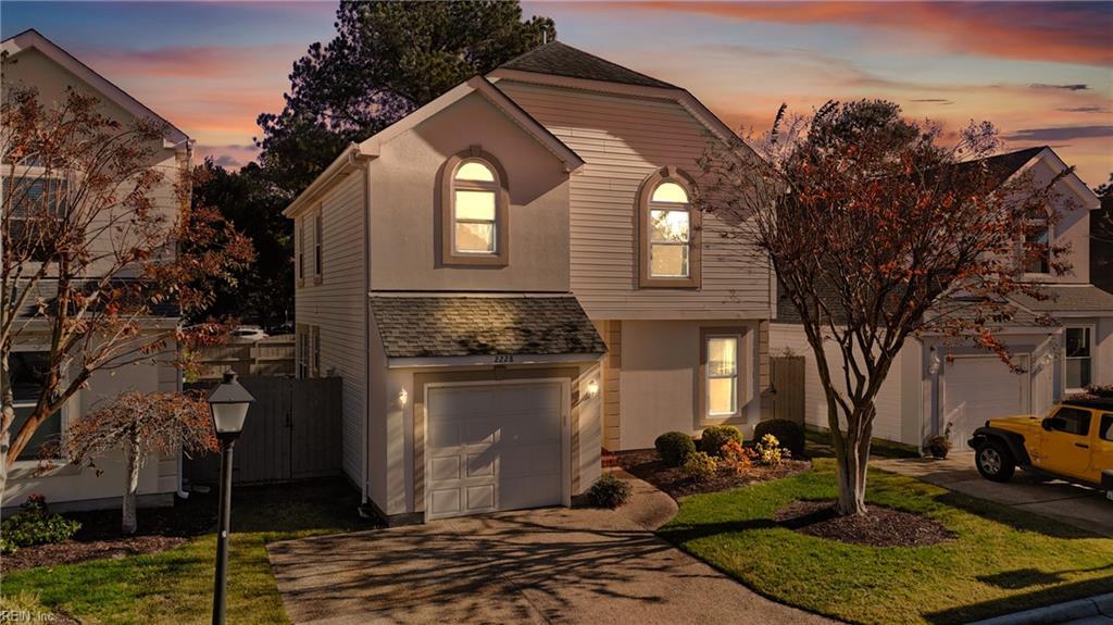 view of property with a yard and a garage