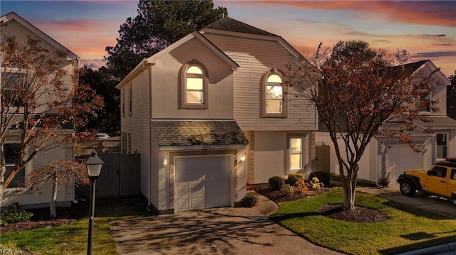 view of property with a yard and a garage