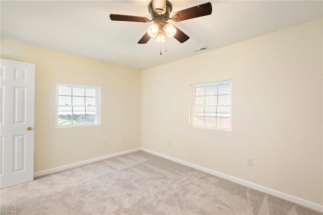 unfurnished room featuring ceiling fan and light carpet