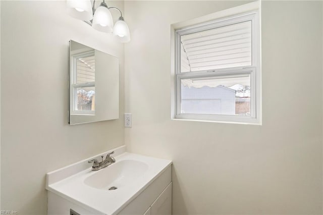 bathroom featuring vanity, a wealth of natural light, and an inviting chandelier