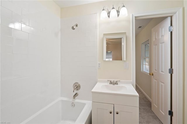 bathroom featuring vanity and tiled shower / bath combo